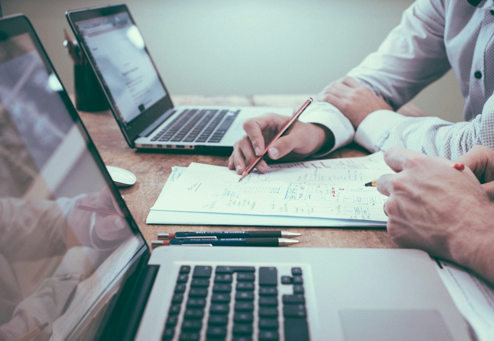Planning documents, charts and a laptop on a desk